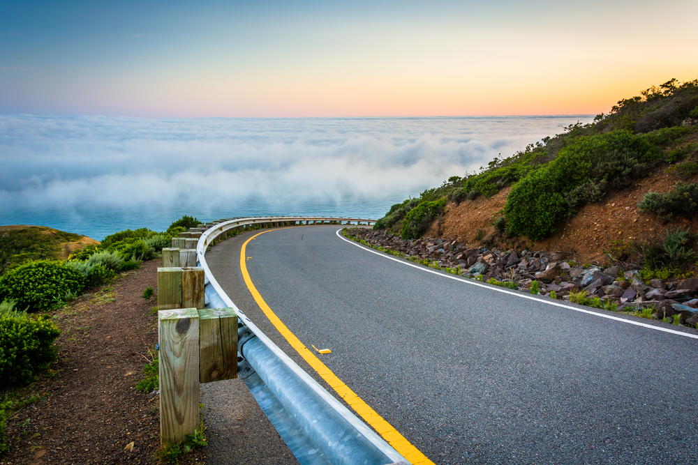 Road and view of fog over the San Francisco Bay, Golden Gate National Recreation Area, in San Francisco, California.